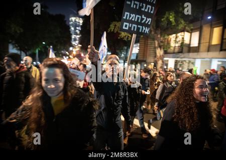 Israel. 14. Januar 2023. Demonstranten marschieren auf den Straßen neben Schildern, die besagen: "Netanjahus Vermächtnis - ein Bürgerkrieg". Mehr als 80.000 Menschen protestierten in Tel Aviv gegen Netanjahus rechtsextremen Regierungs- und Justizüberholung. Januar 14. 2023. (Foto: Matan Golan/Sipa USA). Kredit: SIPA USA/Alamy Live News Stockfoto