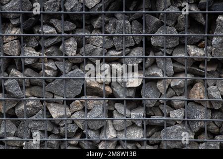 Die Giftgabion aus dem Steinzaun ist tagsüber im Freien Stockfoto