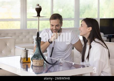 Ein glückliches Paar, das sich in der Hookah Lounge trifft, sich im Teehaus trifft Stockfoto