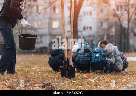 Aufforstung oder Kinder lernen oder helfen, Bäume im Freien zu Pflanzen Stockfoto