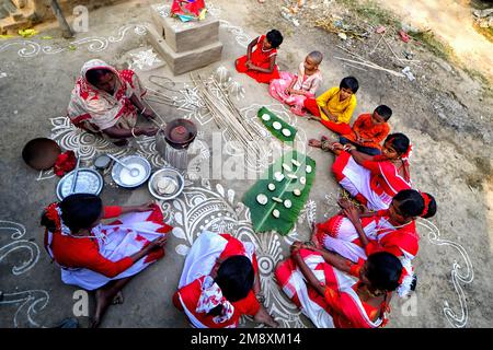 Stammesfrauen haben gesehen, wie sie PiThe zubereitet haben - hergestellt aus Reismehl während des Makar Sankranti (ein wichtiges Festival in Bengal, wenn der Sonnensolf verehrt wird) in einem abgelegenen Dorf von Shantipur. Stammesgemeinde Menschen aus dem ländlichen Bengal Indiens feiern das Tusu Festival am Tag von Makar Sankranti (markiert den Übergang der Sonne vom Sagittarius zum Capricorn) für die letzten 100 Jahre. Dieses Festival wird hauptsächlich von jungen Mädchen gefeiert, die farbenfrohe Chowdal (handgefertigte bunte Gegenstände), dekorative Pflanzen und süße Gerichte namens PiDie im tragen Stockfoto