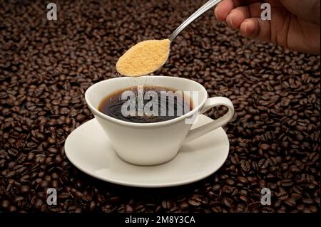 Eine Tasse Kaffee auf braunen Kaffeebohnen Stockfoto