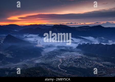 Sonnenaufgang im Vall de Lord Tal mit Nebel über dem Reservoir und rötlichen Wolken. Gesehen von Port del Comte (Solsonès, Lleida, Katalonien, Spanien) Stockfoto