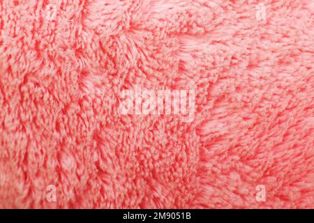 Pinkfarbene, flauschige Textilstruktur. Windel, haarig, Hintergrund, Nahaufnahme Stockfoto
