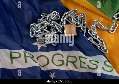 Kette, Vorhängeschloss und brasilianische Flagge symbolisieren die Sklaverei im Land Stockfoto