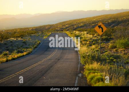 Eine Straße, die durch Sandsteinformationen im Valley of Fire State Park, Nevada, USA führt. Den amerikanischen Südwesten erkunden. Stockfoto