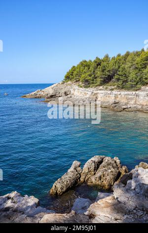 Vertikale Sicht auf die Adria mit Felszene in Kroatien. Wunderschöne Felsenküste mit Wasser und blauem Himmel im sonnigen Sommer in Pula. Stockfoto