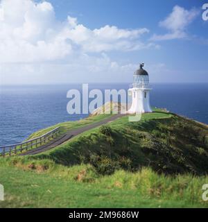 Blick auf den Leuchtturm am Cape Reinga, am nördlichen Ende der Nordinsel, Neuseeland. Der Leuchtturm wurde 1941 erbaut. Im Jahr 1987 wurde sie vollständig automatisiert, und die Leuchtturmwärter wurden zurückgezogen. Nach den Überzeugungen der Maori ist Cape Reinga der Punkt, an dem die Geister der Toten die Unterwelt betreten, indem sie von einem 800 Jahre alten Kahika (oder Kahikatea) Baum springen. Stockfoto