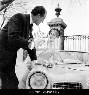 Werbung für lebenslange Zigaretten -- männliche und weibliche Modelle (Helen Connor und Christopher Powell) mit Facel Vega-Auto. Stockfoto