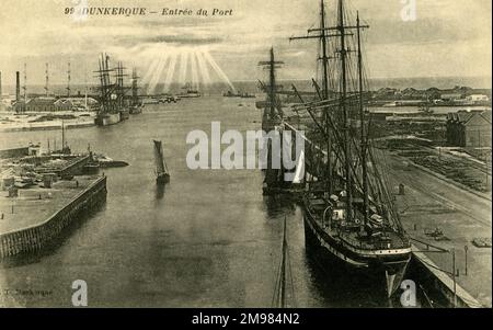 Schiffe und kleinere Boote säumen den Eingang zum Hafen der französischen Stadt Dünkirchen (Dünkirchen). Stockfoto