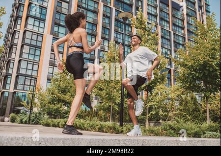 Junger Mann, der draußen mit seinem Fitnesspartner trainiert Stockfoto