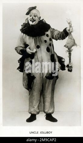 Clown Onkel Jolliboy - hält ein falsches Huhn in der Hand Stockfoto