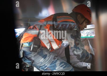 Pokhara, Nepal. 17. Januar 2023. Bewaffneter Polizist lädt die Leichen der Flugzeugabsturzopfer der Yeti-Fluggesellschaften in einen Krankenwagen zur Obduktion in Pokhara. Ein Flugzeug der Yeti Airlines stürzte am Sonntag, den 15. Januar, in Pokhara ab, als es von Kathmandu nach Pokhara mit 68 Passagieren und vier Besatzungsmitgliedern an Bord flog, und 71 Leichen wurden bis Dienstagabend geborgen, viele Leichenteile wurden an der Absturzstelle gefunden. Kredit: SOPA Images Limited/Alamy Live News Stockfoto