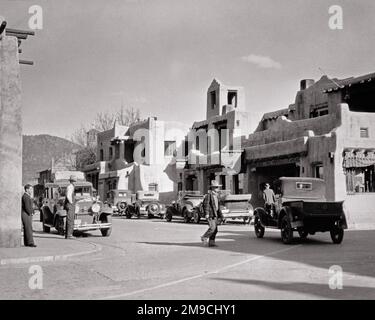 1920S MÄNNER FUSSGÄNGER AUTOS AUTOS AUF DER STRASSE VOR DEM LA FONDA HOTEL SANTA FE NEW MEXICO USA - R5657 HAR001 HARS FUSSGÄNGER TRANSPORT B&W NORDAMERIKA FUSSGÄNGERSTRUKTUR IMMOBILIE AUTOS ÄUSSERE IMMOBILIEN AUTOS AUTOS FE SANTA FE FAHRZEUGBAU SÜDWESTEN LEHMZIEGEL NEW MEXICO SCHWARZ-WEISS HAR001 NM ALTMODISCH SÜDWESTEN Stockfoto