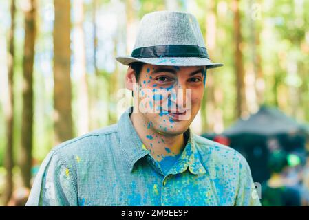 VICHUGA, RUSSLAND - 17. JUNI 2018: Festival of Colors Holi. Glücklicher Mann mit einem Gesicht in Farbe Stockfoto