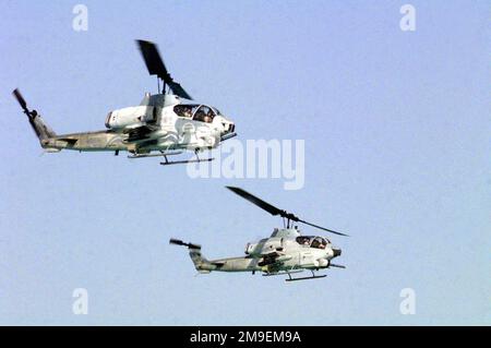 Rechtes Profil mittlere Aufnahme aus einem niedrigen Winkel nach oben mit zwei US Marine AH-1W Supercobra angreifen Hubschrauber während des Fluges, während sie am amphibischen Angriffsteil von Brightstar 1999-2000 teilnehmen, der im Oktober und November in Ägypten stattfand. Betreff Betrieb/Serie: BRIGHTSTAR 1999-2000 Land: Ägypten (EGY) Stockfoto