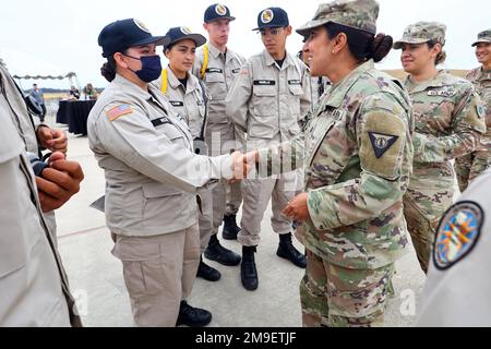 USA Oberstleutnant Manju Vig, Garnisonskommandeur der Joint Forces Training Base, Los Alamitos, Münzen, Sunburst Youth Challenge Academy Klasse 29, Kadett Angel Vicente und andere Kadetten, die die Farben während einer bahnbrechenden Zeremonie am 19. Mai 2022 präsentierten, Für ein Projekt zur Stärkung der Energieversorgung auf der Joint Forces Training Base in Los Alamitos, Kalifornien. Die Sunburst Youth Challenge Academy befindet sich auf der Anlage, und Kadetten unterstützen häufig Veranstaltungen auf der Basis. Stockfoto