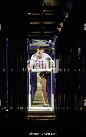 US Air Force Captain Jeff Kuzma, Raumfahrttechniker, macht nach einem Training einen Hürdensprung unter der Tribüne. Er trainiert, um das US-Olympiateam auf dem 800-Meter-Lauf zu werden. CPT Kuzma ist Teil des World Class Athlete-Programms, das aktiven Duty-, Guard- und Reserve-Athleten die Möglichkeit bietet, bis zu zwei Jahre in Vollzeit in ihrem Sport zu trainieren. Bei jedem Wetter läuft CPT Kuzma meilenweit um das Gelände der Air Force Academy. Sein Ziel ist die Olympiamedaille und die Stärkung der Anerkennung und des Bewusstseins der Air Force in der Öffentlichkeit, 21. Juni 2000. Basis: US Air Force Stockfoto