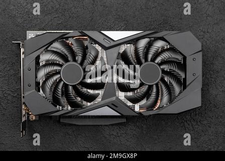 Computer graphic card, professional video card with two fans on black concrete background. Top view Stock Photo