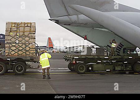 Royal Air Force Neuseeland Bodenunterstützung mit K-Ladern im Tandem beladen einen Lockheed C-141 Starlifter aus dem 452. Air Mobility Wing, der auf der Rampe in Christchurch, Neuseeland geparkt ist, um die Operation DEEP FREEZE 2001 zu unterstützen. Im Hintergrund ein LC-130H Hercules von der 109. Air National Guard Unit aus New York. Der C-130 ist mit Skiern ausgestattet. Betreff Operation/Serie: TIEFKÜHL 2001 Basis: Christchurch Staat: Canterbury Land: Neuseeland (NZL) Szene Hauptkommando gezeigt: AMC Stockfoto