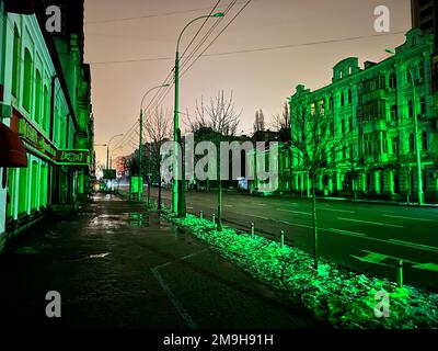 Kiew, Ukraine - 14. Januar 2023: Stromausfall in den ukrainischen Straßen ohne Straßenbeleuchtung reflektiert nur die Farbe der Ampel Stockfoto