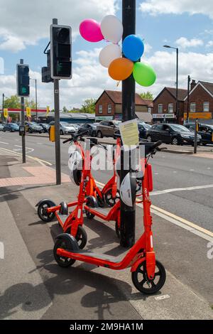 Slough, Großbritannien. 10. Juni 2022. Das von der Firma Neuron Mobility betriebene Testmietprogramm für E-Scooter in Slough wurde um weitere zwei Jahre verlängert. Die orangefarbenen Roller sind zwar beliebt, aber im Allgemeinen wurden E-Roller kritisiert, da einige Benutzer auf Gehwegen und Straßen mit ihnen zu Unfällen fahren. Es wurde auch berichtet, dass einige Konsumenten unter dem Einfluss von Alkohol stehen, wenn sie sie verwenden, insbesondere nachts. Kredit: Maureen McLean/Alamy Stockfoto