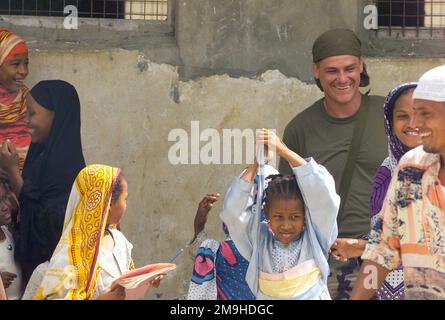 Corporal Scott E. McLain, USMC, Landing Support SPECIALIST, MEU Service Support Group 13 (MSSG-13), 13. Marine Expeditionary Unit (Special Operations Capable) (MEU (SOC)) interagiert mit den kenianischen Schulkindern in der Nähe des Schulhauses in Faza, Kenia. Die Marines sind dort als Teil eines Teams, die ein wenig mehr leisten, um während DER EDGED MALLET 02 ein neues Schulhaus als Teil der Gemeinschaftsbeziehungen zu bauen. Betreff Operation/Serie: KANTENHAMMER 02 Basis: Faza Staat: Küstenland: Kenia (KEN) Szene Hauptkommando gezeigt: 13 MEU Stockfoto