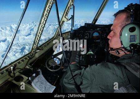 Captain (CPT) des United States Marine Corps (USMC) Jeffrey Murphy, Marine Aerial Tanken Transport Squadron (VMGR) 452, vom Stützpunkt der Stewart Air National Guard (ANG), Newburg, New York (NY), blickt vom Flugdeck seines KC-130 Tankflugzeugs aus auf die Alaska Range, um Northern Edge 2002 zu unterstützen. Basis: Luftwaffenstützpunkt Elmendorf Bundesstaat: Alaska (AK) Land: Vereinigte Staaten von Amerika (USA) Stockfoto