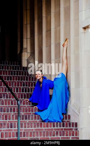 Acrobat in blue dress stretching on staircase, University of Washington, Seattle, Washington State, USA Stock Photo