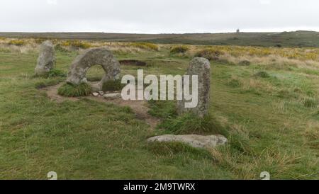 Männer-an-Tol, Steine in der Nähe von Madron, West Cornwall, England, Großbritannien, mit dem Greenbarrow Engine House am Horizont. Stockfoto