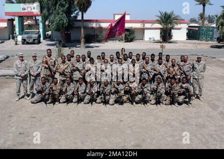 040605-M-5555L-102. [Complete] Szene: AUSBILDER DER US Army (USA), die der Hauptverwaltung und Hauptverwaltung (H&HC) zugewiesen sind, 1. Brigade, 1. Infanterieabteilung, posieren für ein Gruppenfoto mit den Kommandos des irakischen Zivilschutzkorps (ICDC), bewaffnet mit 5,56 mm Tabuk-Sturmgewehren, Nach Abschluss eines Trainingskurses in der Nähe des Camp Hurricane Point am Stadtrand von Ar Ramadi, Irak. US Soldier, der der US Marine Corps (USMC) 1. Marine Division (MARDIV) angeschlossen ist, ist an der Ausbildung von ICDC-Soldaten beteiligt, während sie Sicherheits- und Stabilisierungsoperationen (SASO) in der Al durchführen Stockfoto