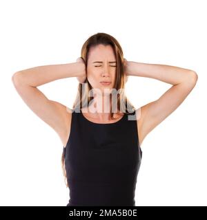 Woman, covering ears and isolated on a white background standing alone for noise, loud or anxiety. Disturbed female, person or lady with hands on ear Stockfoto