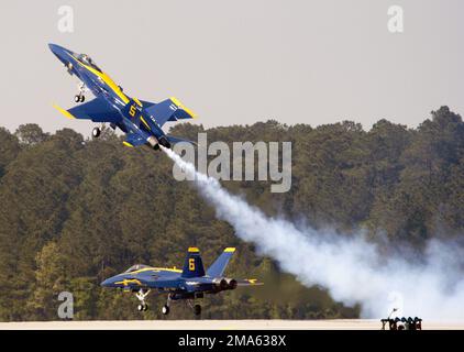 US Navy (USN) Lead Solo Pilot, Lieutenant Commander (LCDR) Craig R. Olson (Vordergrund), dem Flugdemonstrationsteam der US Navy (USN) zugeteilt, das 'Blue Angels', zieht sein F/A-18A Hornet-Flugzeug als gegnerischer Alleinpilot, Lieutenant Commander (LCDR) Theodore J. Steelman, Die 2005 Air Show, die an der Marine Corps Air Station (MCAS) Cherry Point, North Carolina (NC) stattfindet, fliegt weiter tief auf der Landebahn. Basis: MCAS, Cherry Point Bundesstaat: North Carolina (NC) Land: Szene der Vereinigten Staaten von Amerika (USA) Hauptkommando gezeigt: MAGTF Stockfoto