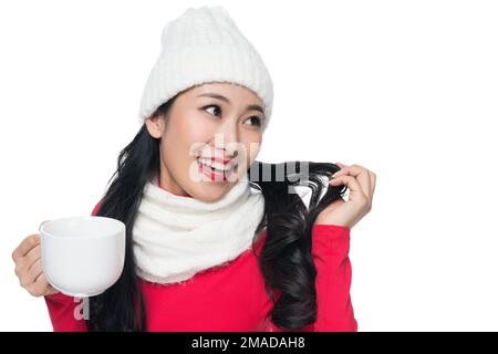 Die junge Frau trinkt etwas Stockfoto