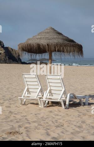 Felsen und Sonnenliegen und Pfad auf Odeceixe; Strand; Algarve; Portugal Stockfoto