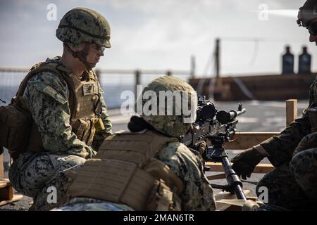 Der Konstrukteur der US-Marine, Ty Mathis, und die Baumeisterin Hannah Doge der Klasse 3., mit der Marine Expeditionary Unit 31., bereiten sich darauf vor, während eines Live-Schießers auf dem amphibischen Dock-Landungsschiff USS Rushmore (LSD 47) in der philippinischen See, 28. August 2022, ein M240B Maschinengewehr abzufeuern. Marineinfanteristen und Matrosen führten Waffenschulungen durch, um ihre Marineinfanteristen auf verschiedenen Waffenplattformen weiterzubilden. Die 31. MEU ist an Bord von Schiffen der Amphibious Ready Group von Tripolis im Einsatzbereich der 7. Flotten tätig, um die Interoperabilität mit Verbündeten und Partnern zu verbessern und als A zu dienen Stockfoto