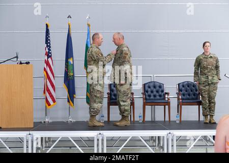 Oberst David Shevtschik, Befehlshaber des 158. Kampfflügels, überreicht dem scheidenden Kommandochef Sergeant Jeffrey Stebbins eine Medaille für den Meritorious Service während der Ermächtigungszeremonie des Kommandoführers auf der Luftwaffenbasis Vermont, South Burlington, Vermont, 4. Juni 2022. Chefmeisterin Adrianne Schulz, die neue Kommandoleiterin des 158. Kampfflügels, ist die erste weibliche Kommandoleiterin in der 7. Dekade der Nationalgarde von Vermont. Stockfoto