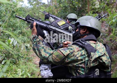 Philippine National Police - Maritime Group, 2. Mitglieder der Spezialeinsatzeinheit und ihre Partner der Spezialeinsatzkräfte der philippinischen Küstenwache nähern sich ihrem Ziel und demonstrieren dabei eine Razzia, die von Polizeihauptmann Valeriano de Leon und Green Berets mit der 1. Special Forces Group (Airborne) am 9. Juni 2022 beobachtet wurde. In der Nähe von Puerto Princesa, Palawan. Dieses Engagement bot den Partnern die Möglichkeit, Taktiken, Techniken und Verfahren untereinander auszutauschen, um die Interoperabilität zu verbessern und gleichzeitig ihre Fähigkeiten zu demonstrieren. Unsere Verbündeten und Partner sind unser größter Vorteil Stockfoto