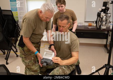 Oberstleutnant Mark Davis, Texas Air National Guard 147. Attack Wing Optometrist assistiert Air Force LT. Joe Rogalinski, 149. Fighter Wing Optometrist mit Optometrie Ausrüstung in Vorbereitung auf Tropic Care 2022 als Hospital Corpsman 1. Class Makayla Carroll, USA Die Marinereservate sieht am 11. Juni 2022 in Lihue, Hawai'i, aus. Tropicare 2022 ist eine innovative Übungsübung zur Bereitschaftsplanung und bietet praxisnahe Schulungen in einem gemeinsamen zivilen und militärischen Umfeld und stärkt die Beziehungen zur Gemeinschaft durch medizinische, zahnärztliche und optometrische Dienstleistungen für die Menschen von Hawai'i. Stockfoto