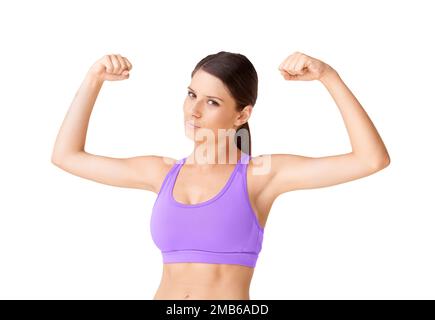 Passen Sie auf die Waffen auf. Porträt einer positiv aussehenden jungen Frau in Sportkleidung, die ihren Bizeps für die Kamera biegt. Stockfoto