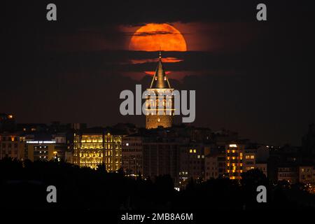 A supermoon rises behind the Galata Tower in Istanbul, Turkey, Tuesday ...
