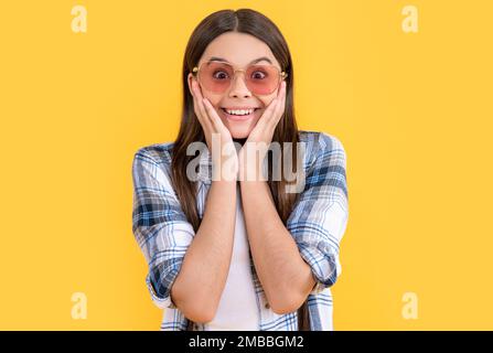 Verblüfftes Teenager-stilvolles Mädchen, isoliert auf Gelb. Teenager-Styling im Studio. Ein stilvolles Teenager-Mädchen Stockfoto