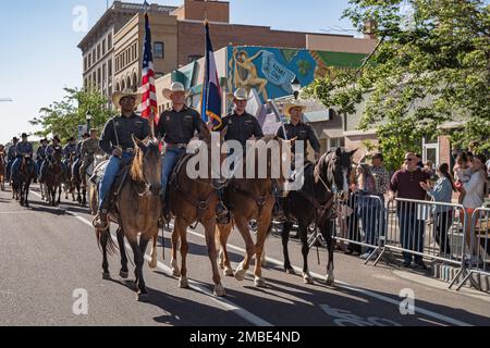 Die 4. Infanterie Division und Fort Carson Mounted Color Guard führen Reiter während des jährlichen Western Breakfast am 15. Juni 2022 in der Innenstadt von Colorado Springs, Colorado. Die Veranstaltung begann mit dem Pikes Peak oder Bust Rodeo, das am 13-16. Juli im Norris-Penrose Event Center stattfindet. Stockfoto