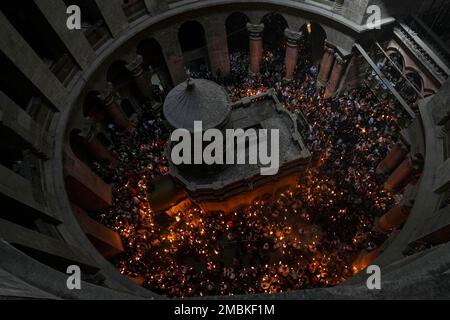 Christian pilgrims hold candles as they gather during the ceremony of