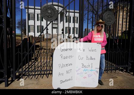 Derenda Hancock, co-director of the Jackson Women's Health Organization clinic patient escorts, better known as the Pink House defenders, stands before the Mississippi Governor's Mansion in Jackson, Friday, Jan. 20, 2023. A small group of abortion rights advocates demonstrated at the building's gates, countering the national March For Life gatherings, while carrying signs calling for abortion rights. A state law banning most abortions, went into effect July 7, 2022. (AP Photo/Rogelio V. Solis)
