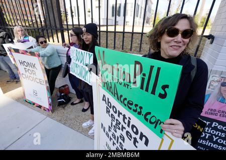Heidi Barnett, a former Jackson abortion clinic escort, right, stands with a small group of protestors before the Mississippi Governor's Mansion in Jackson, Friday, Jan. 20, 2023. The abortion rights advocates demonstrated at the building's gates, countering the national March For Life gatherings, while carrying signs calling for abortion rights. A state law banning most abortions, went into effect July 7, 2022. (AP Photo/Rogelio V. Solis)