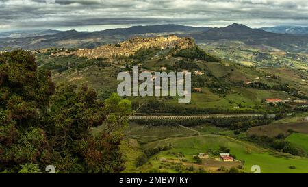 Panoramablick auf das sizilianische Dorf Calascibetta mit Bergen und grüner Landschaft. Die historische arabische Stadt befindet sich auf dem Hügel. Calascibetta, Enna Stockfoto