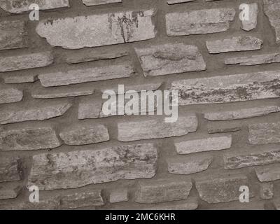 Rustikaler und gealterter Wandstein, Außenwand Stockfoto