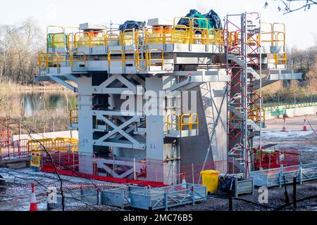 Denham, Großbritannien. 21. Januar 2023. Der HS2 High Speed Rail 2 Colne Valley Viadukt wird derzeit gebaut. Die Brücke überquert nun die A412 London Oribtal Road in Denham, und in dieser Woche wurde ein Meilenstein von 500 Metern erreicht. Dominque, eine riesige, 160m mm lange, orangefarbene, 700 Tonnen schwere Brückenbaumaschine, die als Trägerbalken bezeichnet wird, windet vorgegossene Betonteile auf 56 Pier-Segmente. Der Colne Valley Viaduct wird die längste Eisenbahnbrücke in Großbritannien sein, sobald er fertig gestellt ist. Kredit: Maureen McLean/Alamy Live News Stockfoto