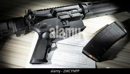 Öffentlich zugängliche NICS-Hintergrundüberprüfungsformular mit AR-15 und Magazin mit hoher Kapazität Stockfoto